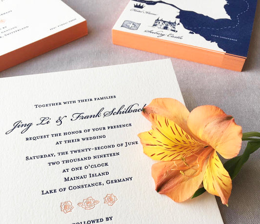Letterpress wedding invitations in a floral design with coral color edge painting
