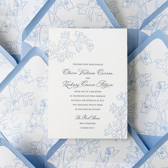 Custom floral letterpressed invitation with coordinating envelope liners