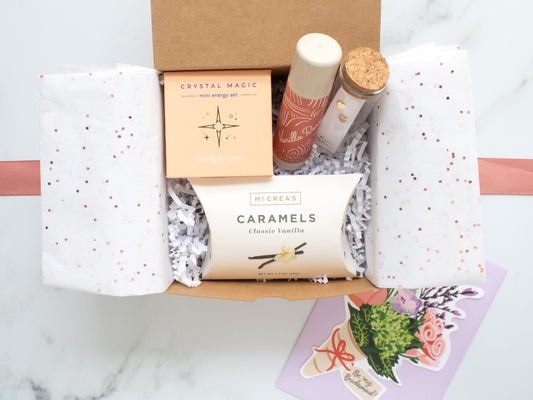 Curated gift box of self care items, caramels, and jewelry with a "will you be my bridesmaid" greeting card